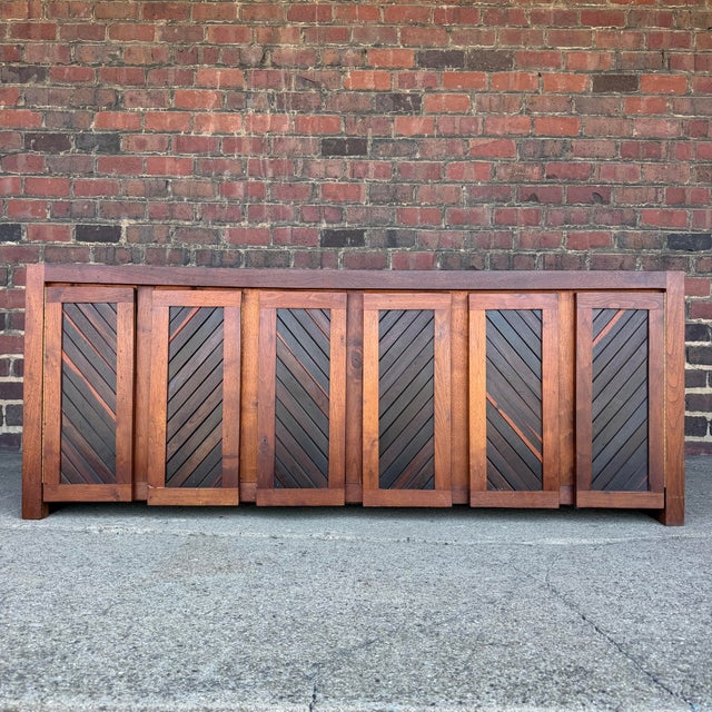 This mid-century studio craft credenza was designed and handcrafted by Jeffrey Greene, an American furniture maker...