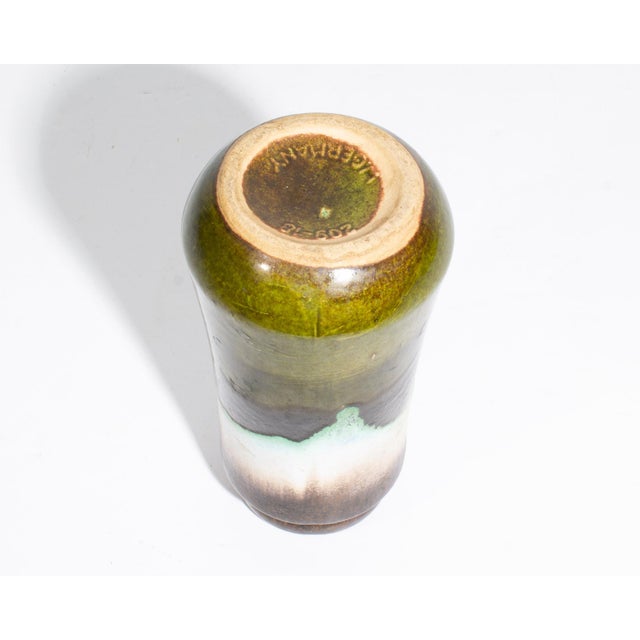 A West German ceramic fat lava vase produced by Scheurich Keramik. This vase features an earthy green, brown, and white...