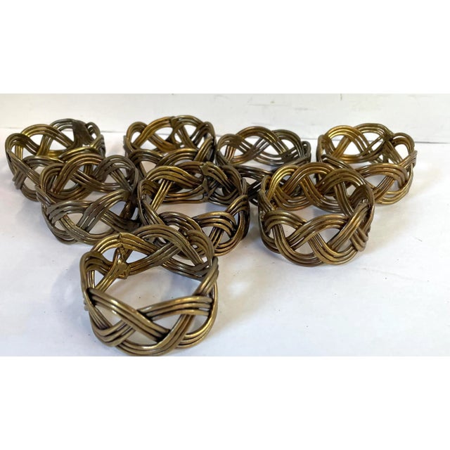Nice set of eight woven metal pattern napkin rings!