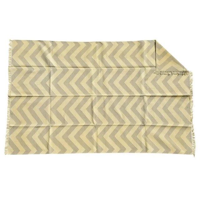 Made from naturally dyed 100% cotton yarn, these dhurrie rugs have been handwoven by skilled craftsmen in Jaipur. The age...