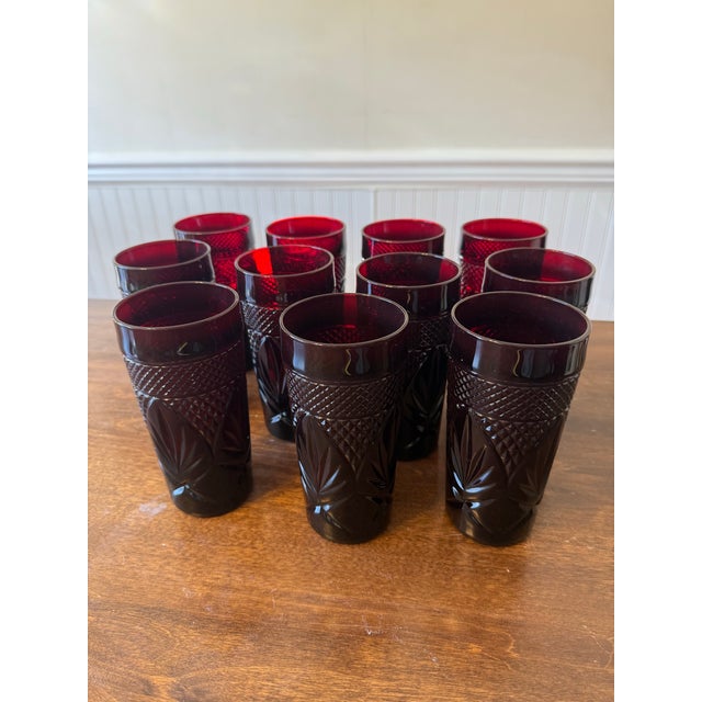 This set of eleven ruby red glasses by Cristal D’ Arques will add a touch of elegance and pop of color to any table...