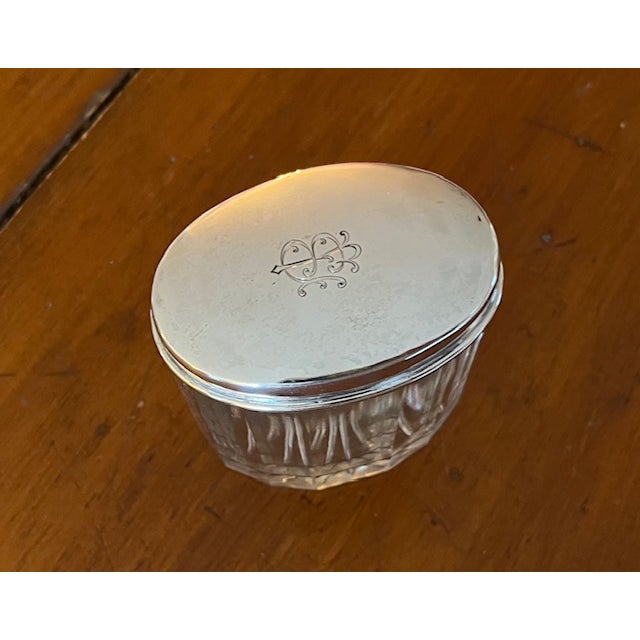 Antique classic traditional style sterling and paneled cut glass vanity jar with monogrammed lid. It measures 3" x 2" and...