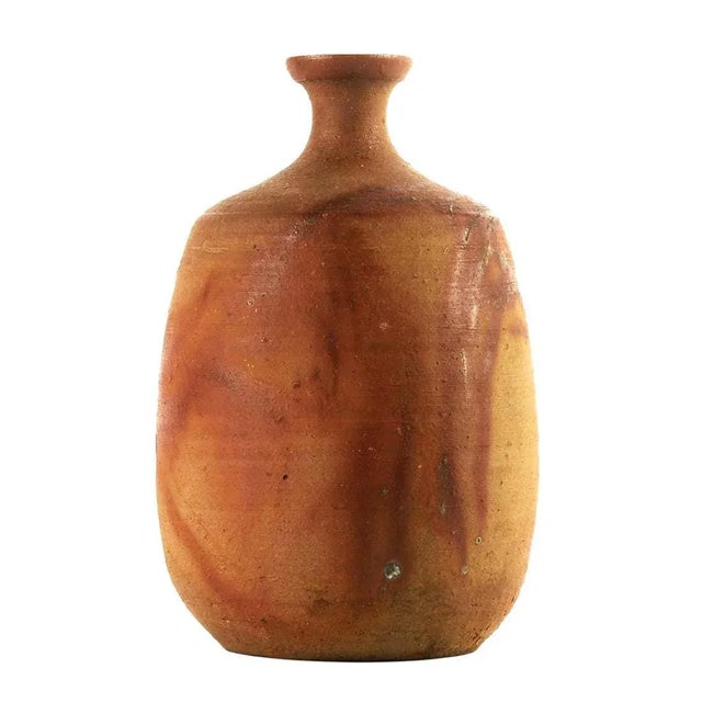 A bottle form vase by Japanese studio ceramic artist Jun Isezaki (Born in 1936). A modern Bizen yaki stoneware piece that...
