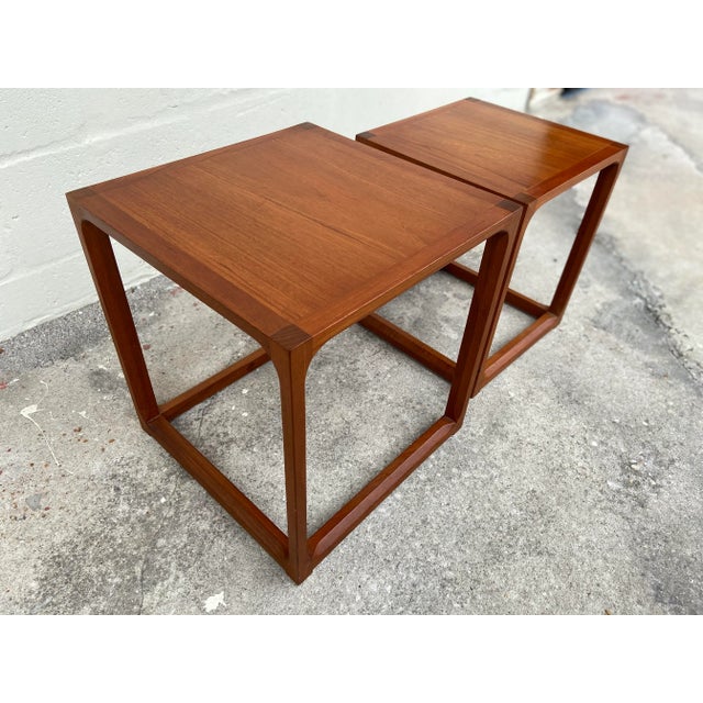 Pair of Kai Kristiansen nesting tables, fine wood joinery, solid teak. Dimensions: Large Table: 15”w x 15”d x 16.25”h...