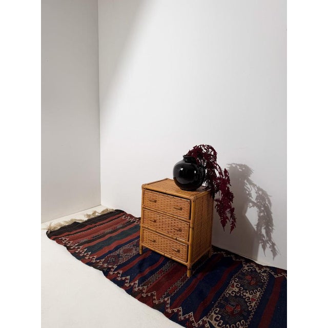 Charming Italian mid-20th century modern small chest of drawers, crafted in plywood and woven cane. Made in Italy circa...
