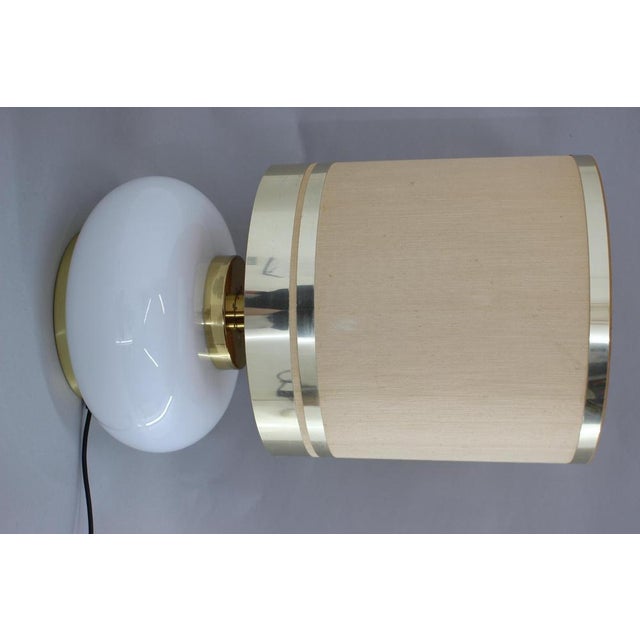 Base part made of glass and brass. Fabric and brass lamp shade. 3 modes of light. Fabric lamp shade with minor signs of...