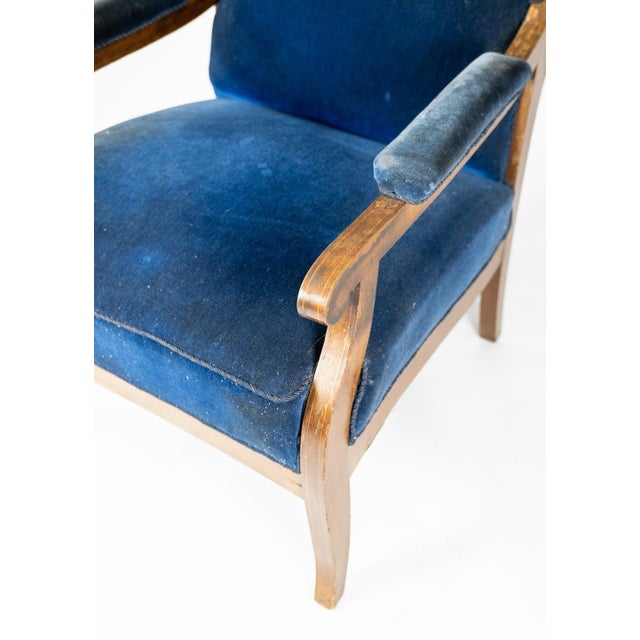 Armchair upholstered with blue velvet and mahogany designed by Fritz Henningsen. The chair is in great vintage condition....