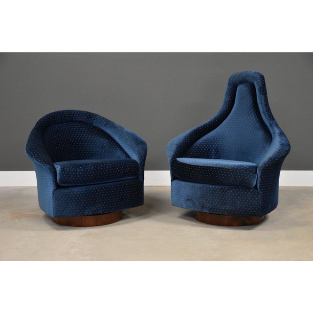 A pair of mid century modern walnut base swivel tilt lounge chairs designed by Adrian an Pearsall for Craft Associates....