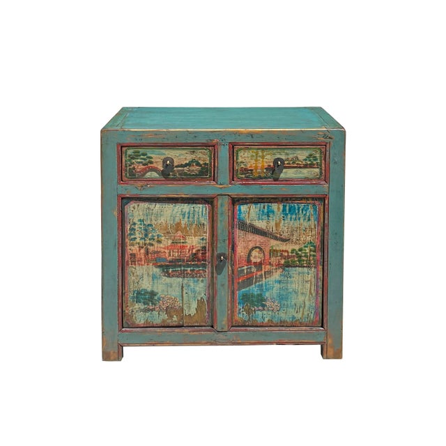 This is an oriental cabinet finished with distressed rustic blue turquoise color with a mix of color patina. The scenery...