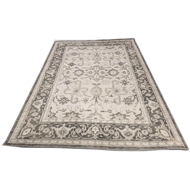 This handwoven Indian rug is a stunning recreation of a classic Persian design, crafted using the finest materials to...