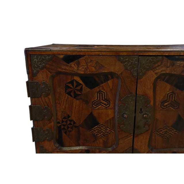 Wonderful Raised Japanese Cabinet Crafted With Geometrically Intricate Inlayed Wood and Hand Wrought Hardware For Sale - Image 9 of 12