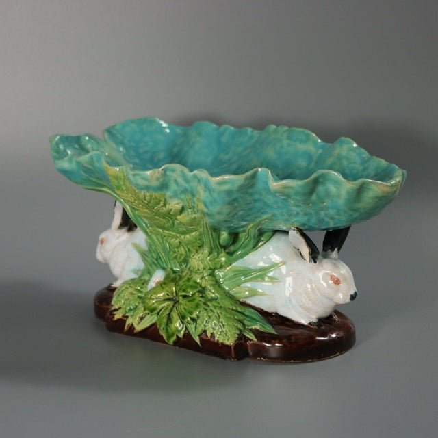 Minton Majolica figural bowl which features two rabbits amongst foliage, supporting a leaf. Colouration: turquoise, green,...