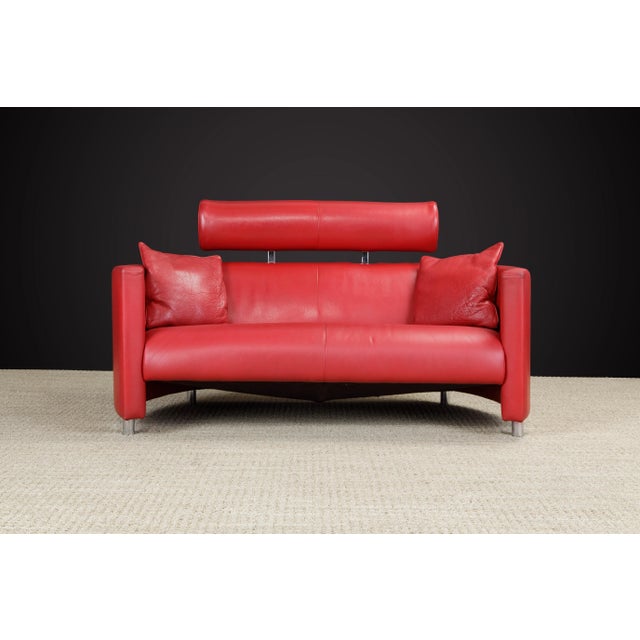 This beautiful red leather Post-Modern loveseat sofa designed by Bernard Massot and produced by Massot, France in circa...