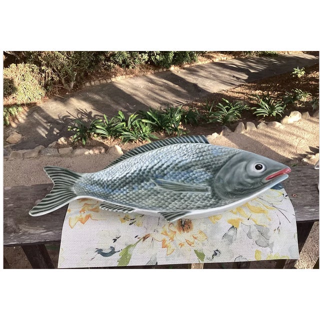 This 1950s Vintage Majolica Fish Platter showcases exquisite hand-painted details and rich, glossy glazes that capture the...
