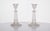 This elegant pair of glass candlesticks features intricate relief work, adding texture and dimension to their refined...