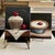Pair of original dessert still life paintings by Jane Palmer, each featuring a richly painted cherry-topped pastry against...