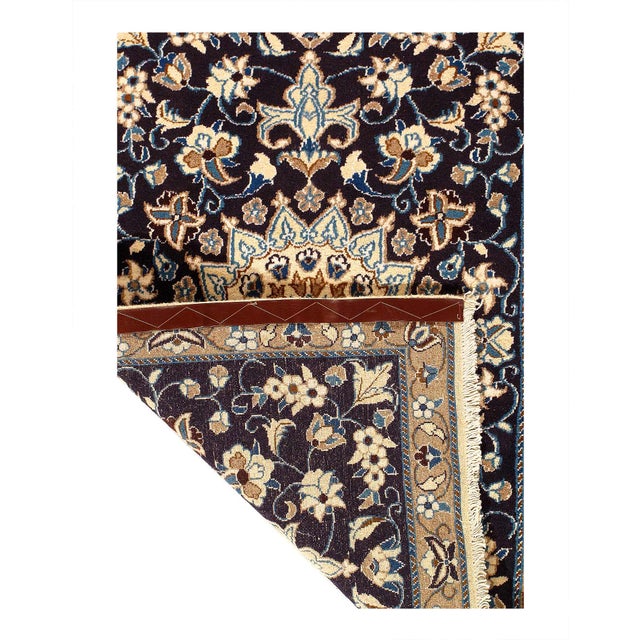 Persian Nain rugs are renowned for their detail and fine use of outlining along the central motifs. Breaking from the...
