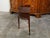An English mahogany demi-lune console table from the 19th century, with a dentil cornice over two reeded tambour sliding...