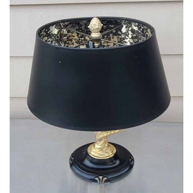 Here is a vintage lamp in dolphin motif. Two gold tone dolphins entwined comprise a stylish base, supporting faux tapers....