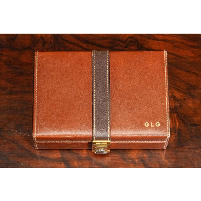 Elevate your dresser or vanity with this exquisite Mark Cross leather accessory box, a refined piece from one of the...