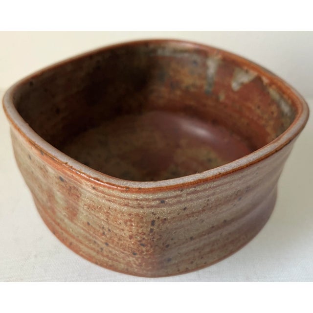 This wonderful and unique asymmetrical studio art pottery bowl features Burnt Orange glaze and is signed on underside....
