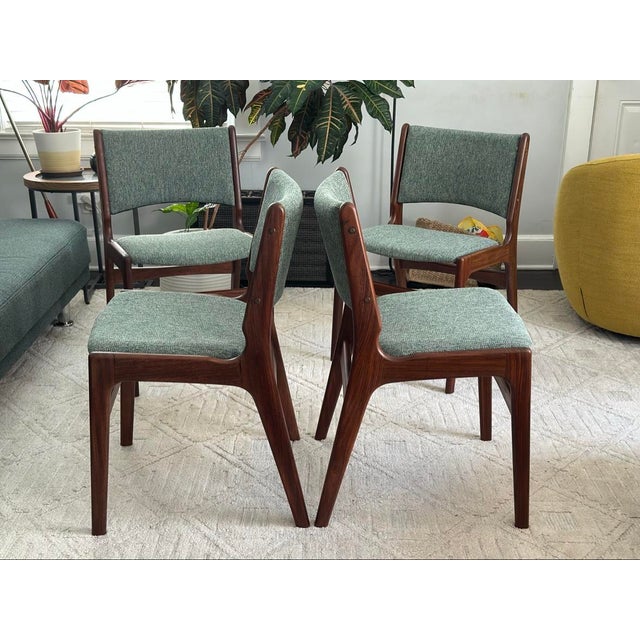 Set of four sculptural Mid-Century Modern Danish dining chairs, Model 89, attributed to Erik Buch. Solid rosewood frames,...
