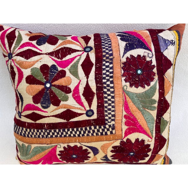Elegant decorative pillow upholstered in a richly patterned Uzbek textile, featuring charming floral flowerhead motifs and...