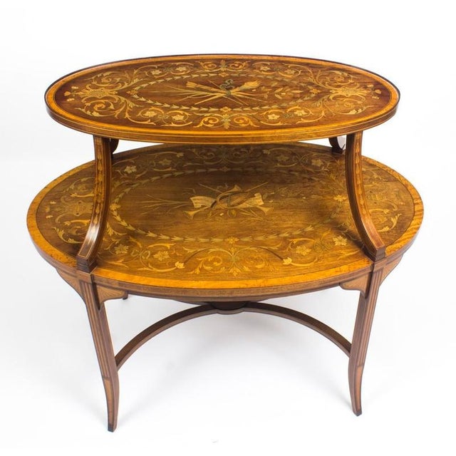 This is a truly exceptional antique English Edwardian mahogany and satin wood marquetry oval two tier 'etagere', in the...