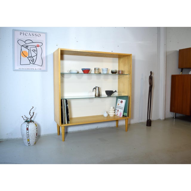 This is an open mid-century modern shelving unit from the renowned company Hellerau, dating from the 1950s. The wooden...