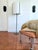 Contemporary Boise floor lamp by Arteriors featuring a slender bronze iron frame anchored by a substantial antique brass...
