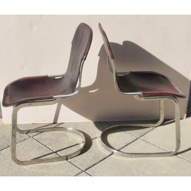Willy Rizzo mid-century-designed chrome steel frames with saddle leather covers. A pair of 2 chair 35" tall and 18" wide....