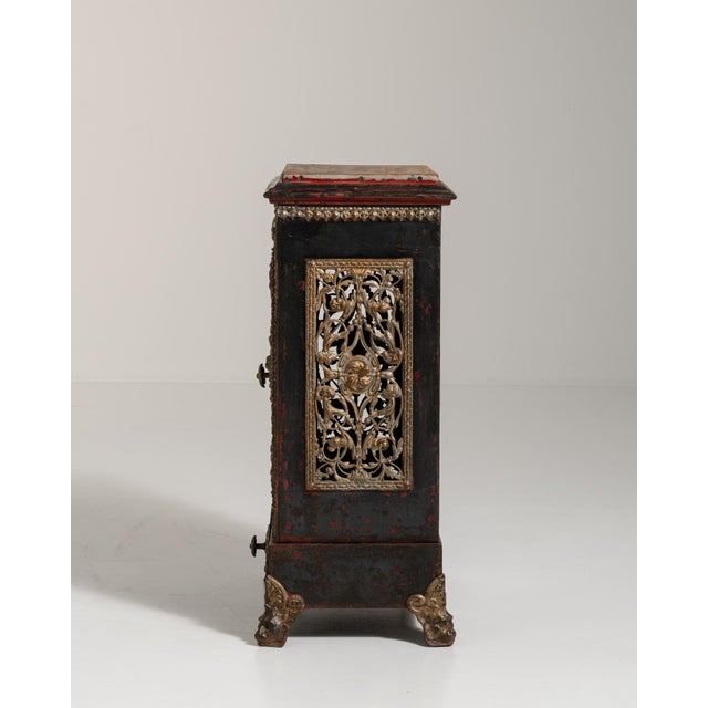 A brown wood, Victorian-style cabinet from the 19th century, made in UK. Crafted in wood with metal detailing, the piece...