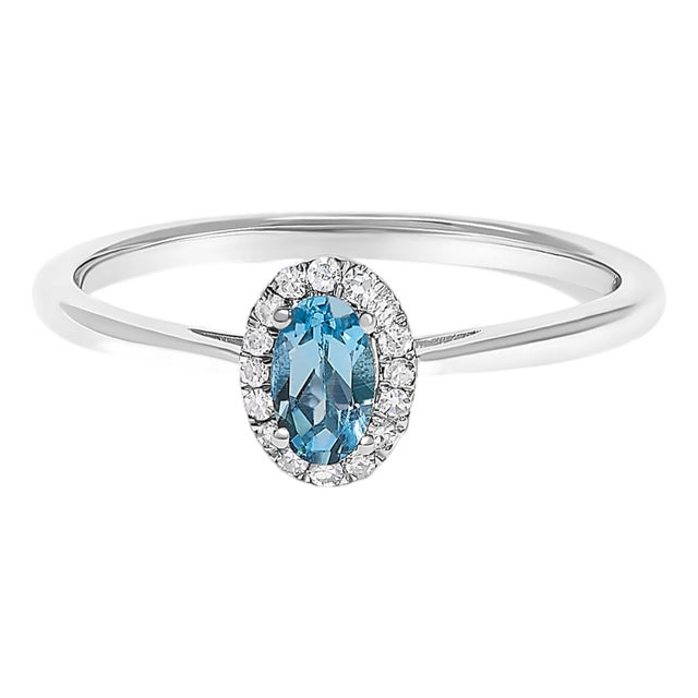 10K White Gold 5X3MM Oval Blue Topaz and Diamond Accent Halo Ring (I-J Color, I1-I2 Clarity) - Ring Size 6 For Sale