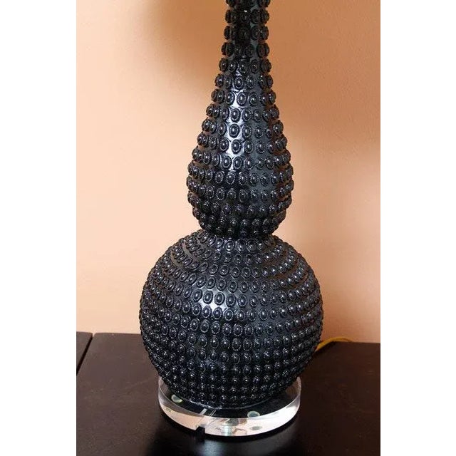 A black high-quality vintage double gourd lamp. The ceramic body is highly textured with a raised pebble-like application....