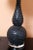 A black high-quality vintage double gourd lamp. The ceramic body is highly textured with a raised pebble-like application....
