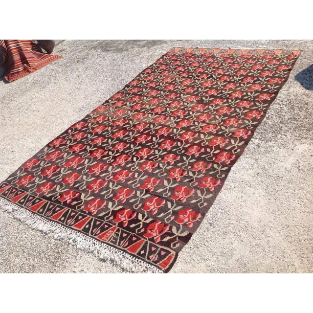 This beautiful, traditional vintage, flatweaved Turkish kilim rug is approximately 60 years old. It is handmade of very...