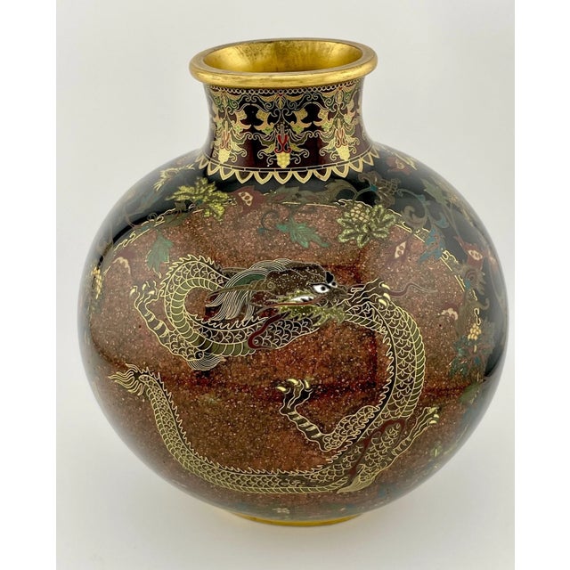 A stunning example of Meiji-era craftsmanship, this Japanese cloisonné vase features a sophisticated dark brown 'gold...