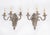 This is a fine antique set of four French Baroque revival silver-plated wall lights circa 1900. They feature shaped shield...