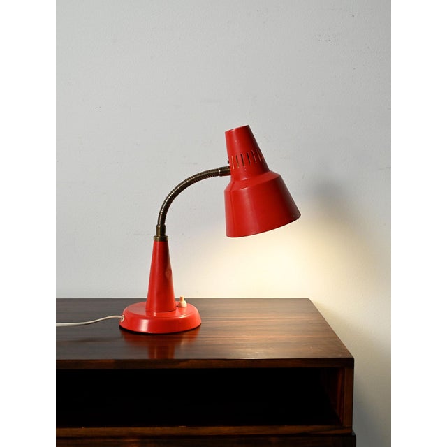 Scandinavian table lamp by Gemi in red lacquered metal, with a flexible, adjustable neck and perforated shade. Table lamp...