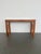 A handsome mixed wood console table featuring a clean silhouette with thoughtful design flourishes. The top is accented...