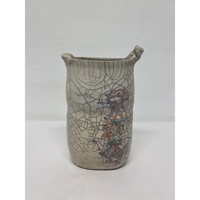 Crackled glaze studio pottery vase with artistic design from the 1980s. Signed by artist.