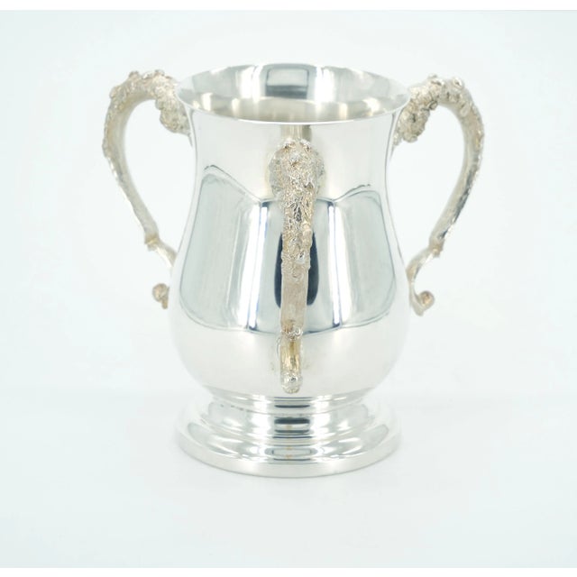 Step into the refined elegance of the 19th century with our English Silver-Plated Three-Handled Cup Vase, perched upon a...