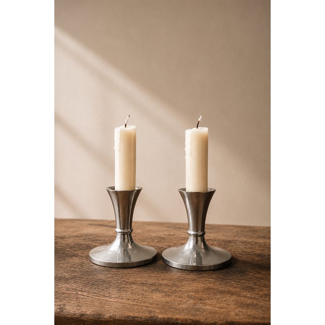This original pair of candlesticks is the work of the famous Danish designer Just Andersen 1884 to 1943 model 2729. An...