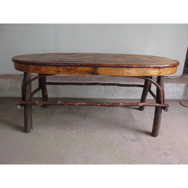 Vintage oval Adirondack Style coffee table. Constructed of mixed woods including oak and birch. Slatted top with natural...