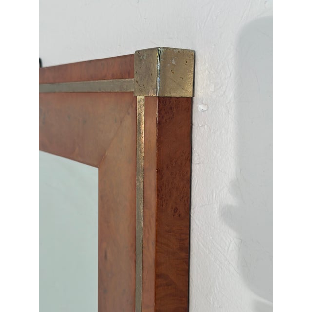 The Vintage Italian Wood & Brass Wall Mirror from the 1980s showcases a perfect blend of wood and brass, with original...