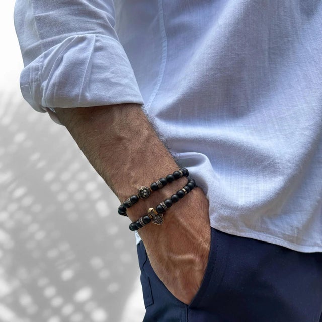 Channel your inner strength and embrace powerful energy with the Powerful Lion & Diamond Arrow Black Onyx Bracelet Set, a...