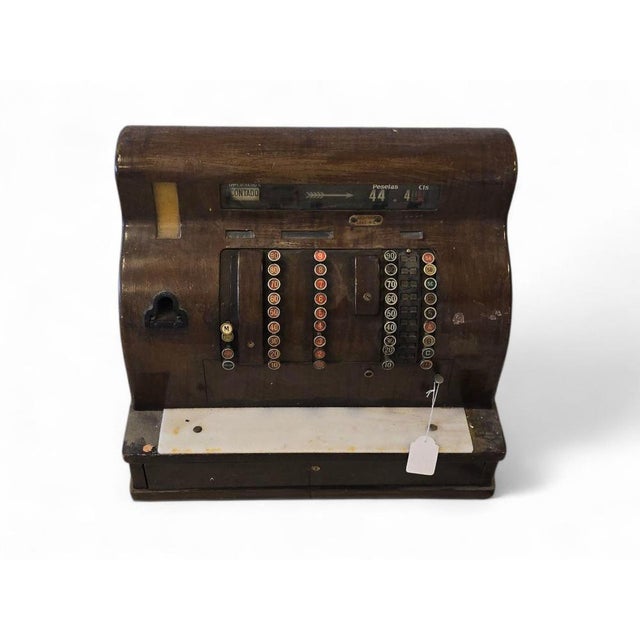 Decorative “National” cash register from the 20th century, made of brass painted in red, with elegant detailing and...