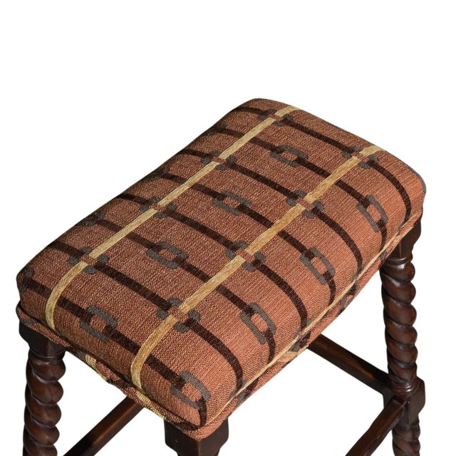 A handsome pair of Vanguard Furniture upholstered counter stools, featuring carved barley-twist legs, a rich espresso wood...