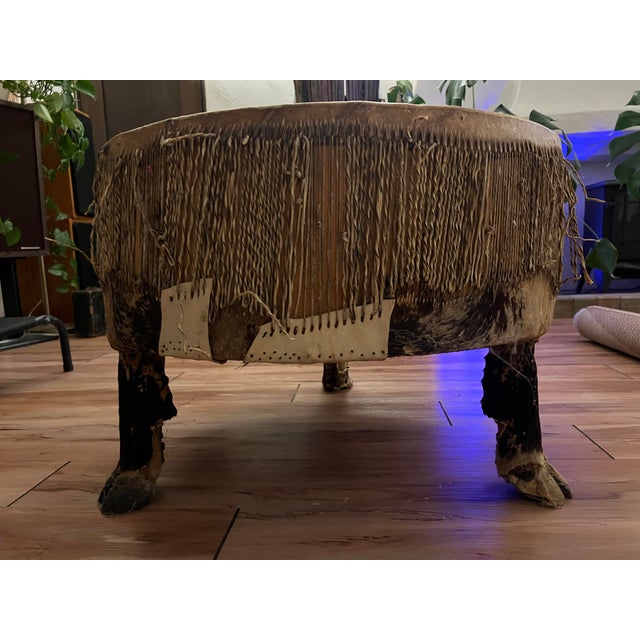 Striking vintage African ceremonial drum repurposed as a sculptural coffee table or statement object. Handcrafted from...