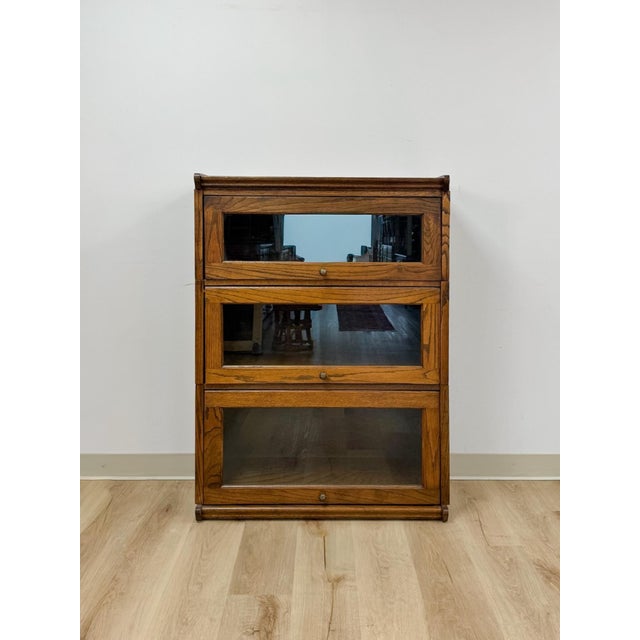 This handsome vintage three section oak barrister bookcase in walnut stain is a beautifully crafted and highly functional...